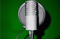 a microphone in front of a green background