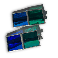 a pair of blue and green glass cufflinks on a black background