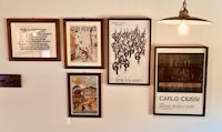 a group of framed posters hanging on a wall