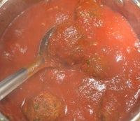 meatballs in tomato sauce with a spoon
