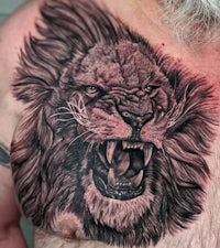 a man with a lion tattoo on his chest