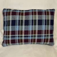 a plaid pillow on a white background