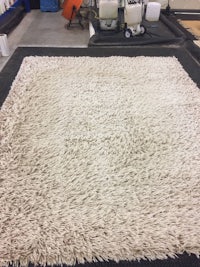 a large white rug in a warehouse
