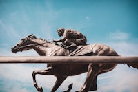 a statue of a jockey riding a horse