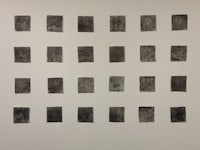 a group of black and white photographs on a wall