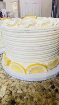a white cake with lemon slices on top