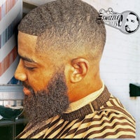 a man with a beard in front of a barber shop