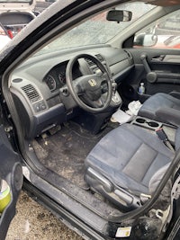 a car with the door open and the steering wheel removed