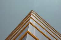 an image of a glass building against a blue sky