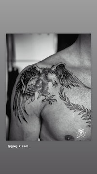 an eagle tattoo on a man's shoulder