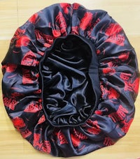 a black and red hat with a red dragon on it