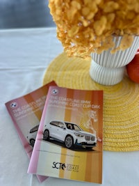bmw brochures on a table with flowers