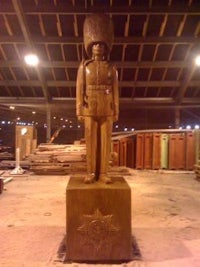 a statue of a soldier in a warehouse