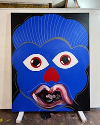a painting of a blue face with red eyes