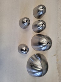 a group of silver metal balls on a table