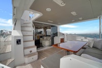 the interior of a luxury yacht with a sofa and a dining table