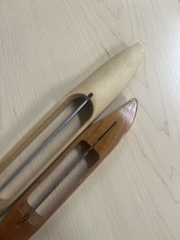 a pair of wooden spoons on a wooden table