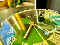 a green clock on a table
