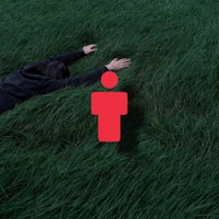 a person laying in the grass with a red icon
