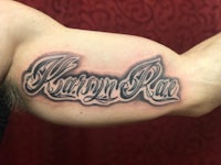 a man's arm with a tattoo that says karryn race