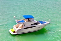 a white and blue boat floating in the water