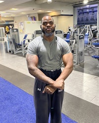a man in a gym posing for a picture