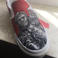 a pair of shoes with a painting of the walking dead
