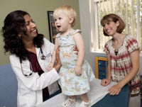 a young girl is being examined by a doctor