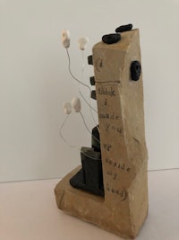 a sculpture of a rock with a microphone on it