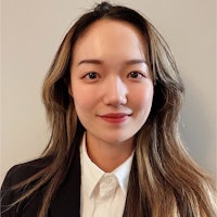 asian woman in a business suit posing for a photo