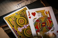 a pair of playing cards on top of an old book