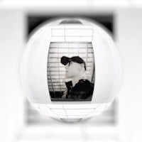 a photo of a man in a hat on a white sphere