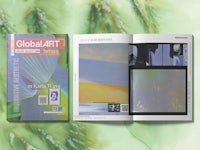 the cover of global art magazine is open on a green background