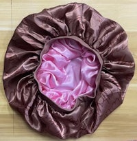 a brown and pink swaddle hat on a wooden floor