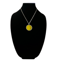 a yellow disc necklace on a mannequin