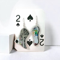 a pair of earrings with playing cards on them
