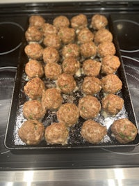 meatballs on a baking sheet in the oven