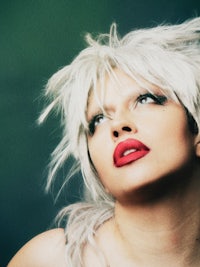 a woman with white hair and red lipstick