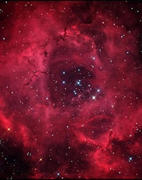 an image of a red nebula with stars in the background