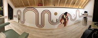 a 360 degree view of a room with a mural on the wall