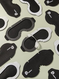 a group of black and white eye masks on a table