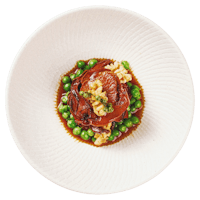 a white plate with peas and meat on it