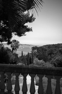 a black and white photo of a balcony overlooking the ocean