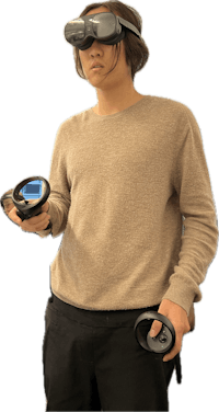 a young man holding a pair of vr goggles