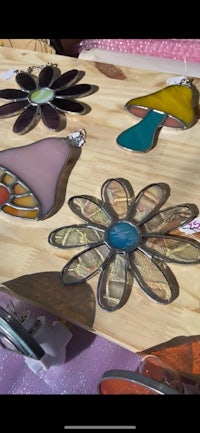 a display of stained glass flowers on a table
