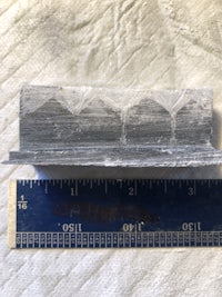 a piece of metal with a ruler next to it