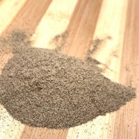 a pile of brown powder on top of a wooden table