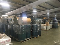 a large warehouse filled with barrels and pallets