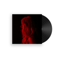 a black lp with a woman in front of a red light