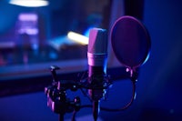 a microphone in a recording studio with blue lighting